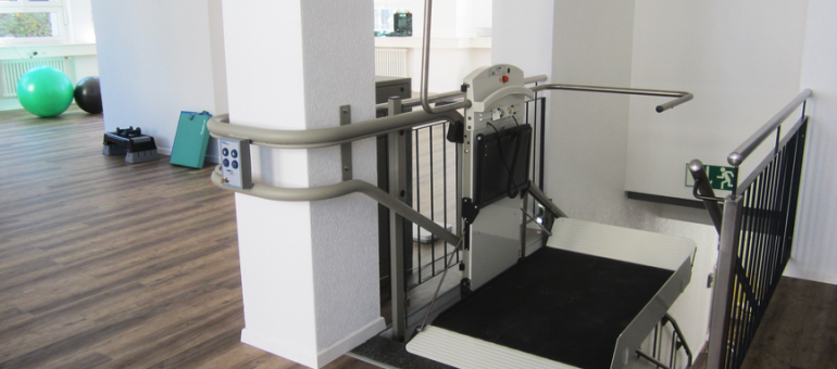 Platform lift in a rehabilitation facility promoting handicap accessibility and mobility aid support.